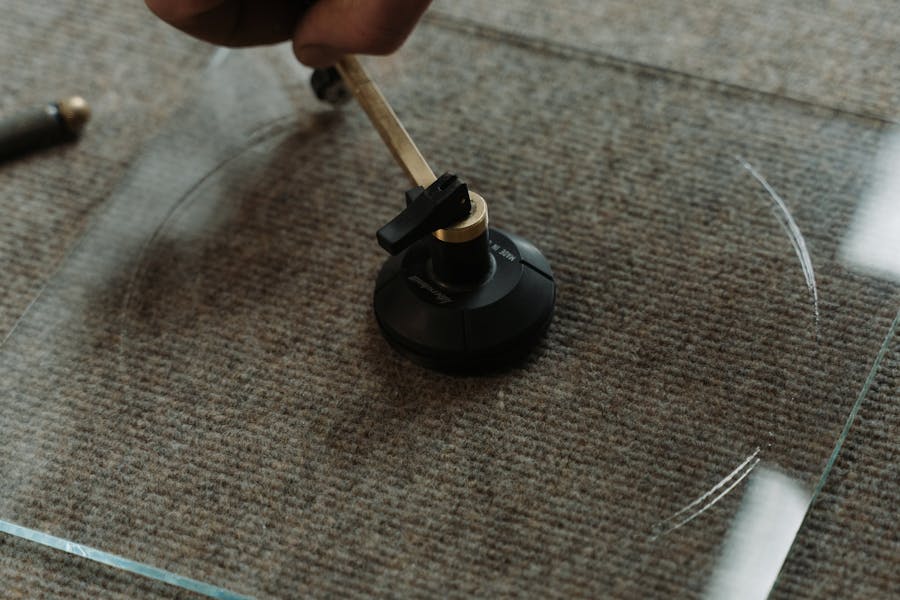 Glass cutter scoring a piece of glass